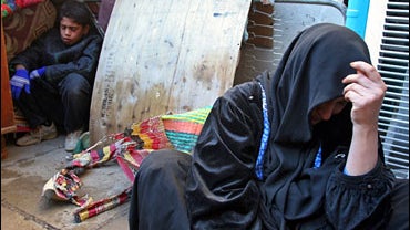 Iraqis react following a military raid in the Shiite district of Sadr City in Baghdad, Iraq 