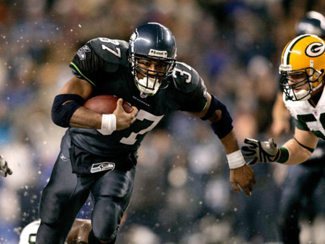 Seahawks Shaun Alexander, right, runs the ball behind a block by News  Photo - Getty Images