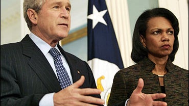 President Bush, left, accompanied by Secretary Of State Condoleezza Rice, gestures while speaking to the media following their meeting at the State Department 