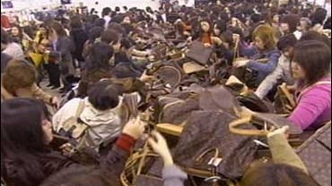 Women search for luxury bags 