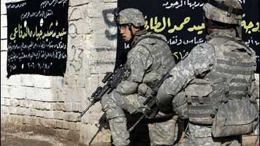 U.S. troops carefully watch an anti-U.S. demonstration in Baghdad 