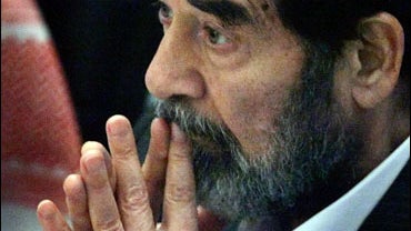 Saddam Hussein listens to the judges during his trial held under tight security in Baghdad's heavily fortified Green Zone in Iraq Wednesday, Oct. 19, 2005. 