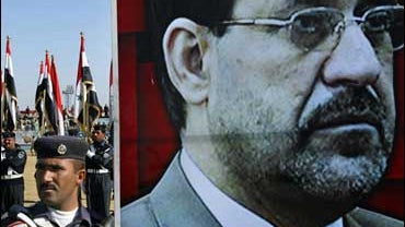 police carry poster of al-maliki 