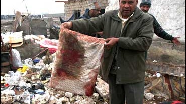 man at destoyed house 