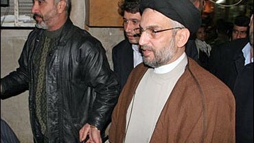 Abdul Aziz al-Hakim, center, head of the Supreme Council for the Islamic Revolution in Iraq party leaves after meeting with Grand Ayatollah Ali al-Sistani in the Shiite holy city of Najaf 