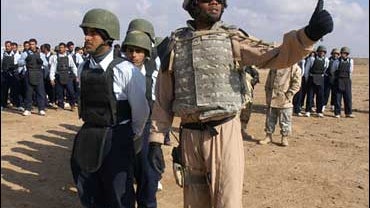 American soldier training Iraqi troops 