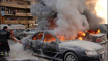Firefighters try to extinguish burning cars after confrontations between Government and opposition members in Beirut, Lebanon Thursday, Jan. 25, 2007. 