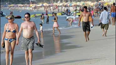 people on beach in thailand 