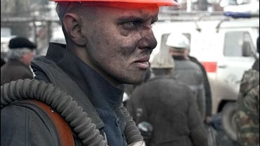 Rescuer Yevgeny Semaikin looks on after returning from Ulyanovskaya mine near Novokuznetsk 