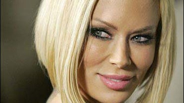 Jenna Jameson poses on the red carpet 