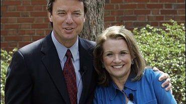 Democratic Presidential hopeful John Edwards hugs his wife Elizabeth while they speak about Elizabeth's recurrence of cancer during a news conference 