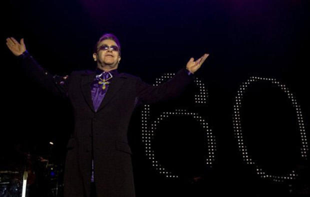 British singer/songwriter Sir Elton John performs with his band at the Dunkin Donuts Center in Providence, R.I., Thursday, Mar. 22, 2007. John will turn 60 on Sunday, Mar. 25, 2007 and big birthday celebration is scheduled during his concert at Madison Sq 
