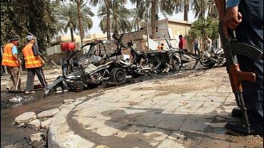 An Iraqi policeman secures the site where a car bomb exploded in central Baghdad, April 10, 2007. 
