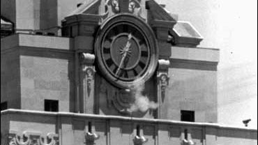 Smoke rises from the sniper's gun as he fired from the tower of the University of Texas administration building on crowds below in this Aug. 1, 1966 file photo. 