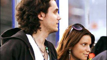 Singers John Mayer and Jessica Simpson walk together 
