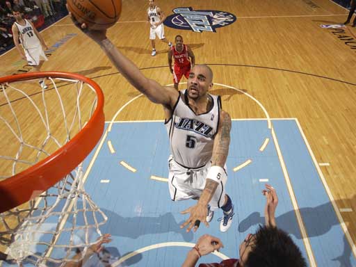 Carlos Boozer (5) of the Utah Jazz takes the ball up over Yao Ming #11 of the Houston Rockets in game 6 of the Western Conference Quarterfinals during the 2007 NBA Playoffs at EnergySolutions Arena on May 3, 2007 in Salt Lake City, Utah. 