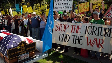 People protest at the main gate of the U.S. Coast Guard Academy in New London, Conn. 