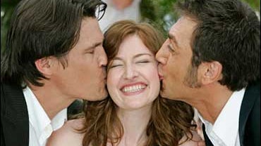 American actor Josh Brolin, left, and Spanish actor Javier Bardem, right, kiss Scottish actress Kelly MacDonald during a photo call for the film "No Country For Old Men," at the 60th International film festival in Cannes, southern France, on Saturday, May 