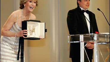 Romanian director Cristian Mungiu, right, waits to accept the Palme d'Or from American actress Jane Fonda for his film "4 Luni, 3 Saptamini Si 2 Zile" ("4 Months, 3 weeks and 2 days"), during the awards ceremony at the 60th International film festival in  