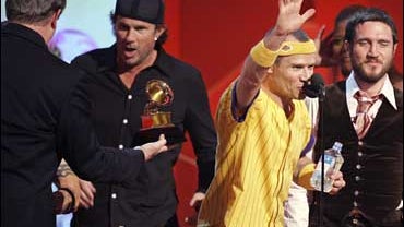 Flea, center, and John Frusciante, far right, of the Red Hot Chili Peppers, accept the award for best rock album for "Stadium Arcadium" at the 49th Annual Grammy Awards on Sunday, Feb. 11, 2007, at the Staples Center in Los Angeles. At left former Vice Pr 