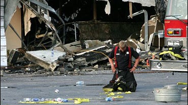 A firefighter takes a moment after helping to put out the fire that claimed the lives of nine Charleston area firefighters 