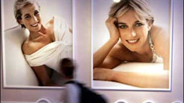 A visitor views pictures, reflected in a mirrored surface, of late Princess Diana, made by photographer Mario Testino, at Kensington Palace in central London, Friday June 29, 2007. " Princess Remembered," a commemorative exhibition celebrating the life of 