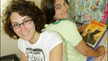 Chloe Bostian, 18, left, and her sister Sydney, 11, take a break from reading in Sydney's bedroom in their Fairbanks, Alaska, home on Saturday, July 21, 2007. The sisters waited for 11 days outside Gulliver's Books in Fairbanks for the first copies of Har 