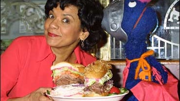 Actress Sonia Manzano who plays Maria Rodriquez on the childrens televison show 'Sesame Street' and the Muppet Grover launch the new 'Super Grover' sandwich in honor of the 4,000th 'Sesame Street' episode February 27, 2002 at the Stage Deli in New York Ci 