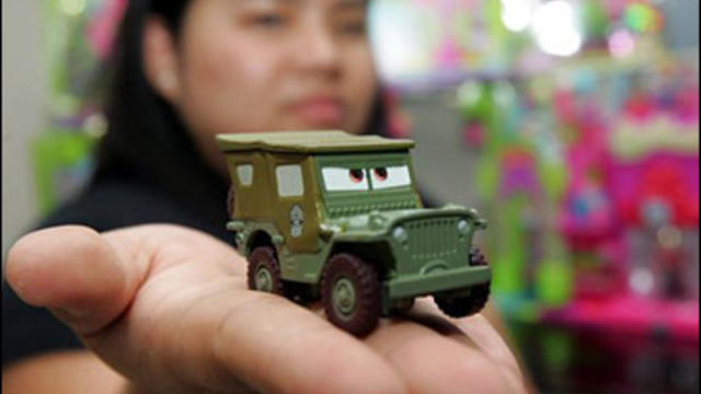 Joy Mirasol of the public relations firm hired by Mattel, shows a recalled toy car named "Sarge" Wednesday, Aug. 15, 2007 in Manila's financial district of Makati. 