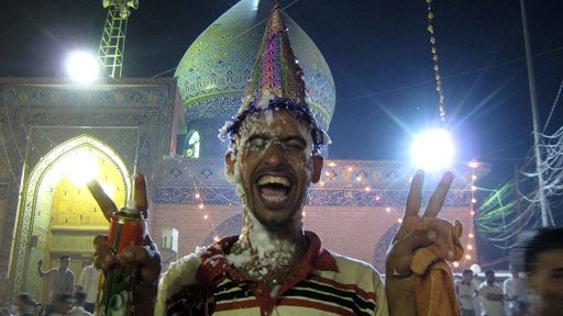 Pilgrims celebrate outside the sanctuary of the 12th and last Shiite Imam al-Mahdi in the Shiite holy city of Karbala 80 kilometers (50 miles) south of Baghdad, Iraq, Tuesday, Aug. 28, 2007. 