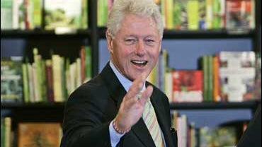 Former US President Bill Clinton waves as he arrives before signing copies of his new book ' Giving: How Each of Us Can Change the World ', at a central London bookstore, Thursday Oct. 4, 2007. The book according too the publishers takes a look at how ind 