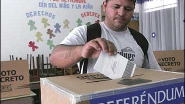 Costa Rican casts his ballot on CAFTA at a polling station 