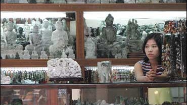 A jade vendor waits for costumer at a market in downtown Yangon, Myanmar 