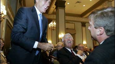 Republican presidential hopeful and former Massachusetts Gov. Mitt Romney shares a laugh with an unidentified Greenville Rotarian member during a campaign stop in Greenville, S.C. Tuesday, Oct. 23, 2007. 