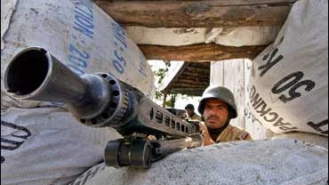 A Pakistani paramilitary soldier takes position at a road side bunker in Mingora 