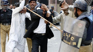 Police officers beat lawyers who were protesting against state of emergency imposed by the military ruler President Gen. Pervez Musharraf, Monday, Nov. 5, 2007 in Lahore, Pakistan. 