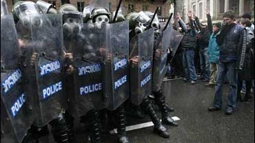 Riot police officers advance toward anti-government protesters in downtown Tbilisi, Wednesday Nov. 7, 2007, driving them from the central part of the capital. 