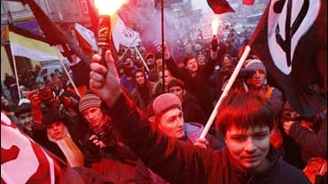 Members of the National Bolshevik party hold their party flags and torches during an opposition rally in Moscow 