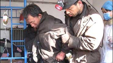 A worker rescued from a coal mine after a gas blast, in Hongtong county, Shanxi province 