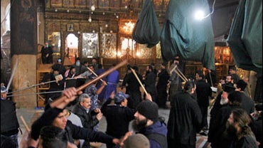 Palestinian police officers intervene in a fight that erupted between Greek Orthodox deacons and Armenian priests during the cleaning of the Church of the Nativity in the West Bank town of Bethlehem, Thursday, Dec. 27, 2007. 