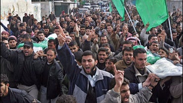 Palestinians carry the bodies of Mohammed Abu Al-Wafa and Mahmoud Abu Taha during their funeral in Khan Younis refugee camp, southern Gaza Strip, Tuesday, Jan. 1, 2008. 