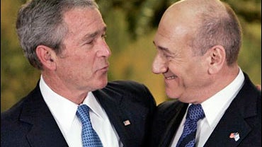 President Bush, left, talks to Israeli Prime Minister Ehud Olmert, right, after a joint news conference following their meeting at Olmert's residence in Jerusalem, Wednesday Jan. 9, 2008. 