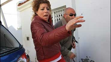 Israelis run for cover as a rocket warning siren sounds in the southern town of Sderot 