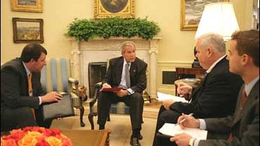 President George W. Bush goes over draft of speech with White House speechwriting staff 
