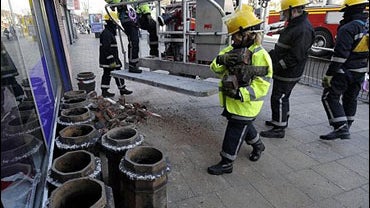Fire crews in Hull, England, Wednesday, Feb. 27, 2008, tackle one of numerous collapsed chimney stacks across the city following an earthquake. 