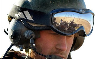 Britain's Prince Harry sitting in his Spartan armoured vehicle 