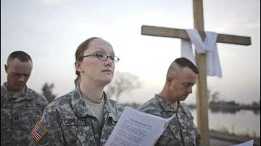 U.S. soldiers read verses as they celebrate Easter with a sunrise service at Camp Victory, in Baghdad 