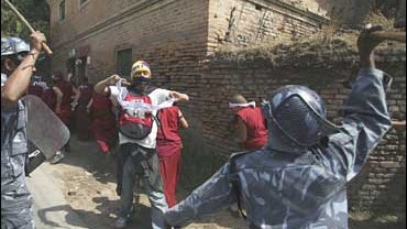 Policemen baton charge scores of exiled Tibetan monks, nuns and people during a protest rally against China 