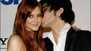 Ashlee Simpson gets a kiss from Pete Wentz of the band Fall Out Boy at the Clive Davis Pre-Grammy Party in Beverly Hills, Calif., Saturday, Feb. 9, 2008. 