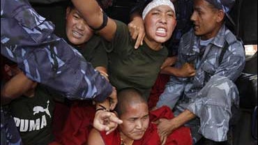 Nepali police officers take away demonstrating Tibetan nuns 